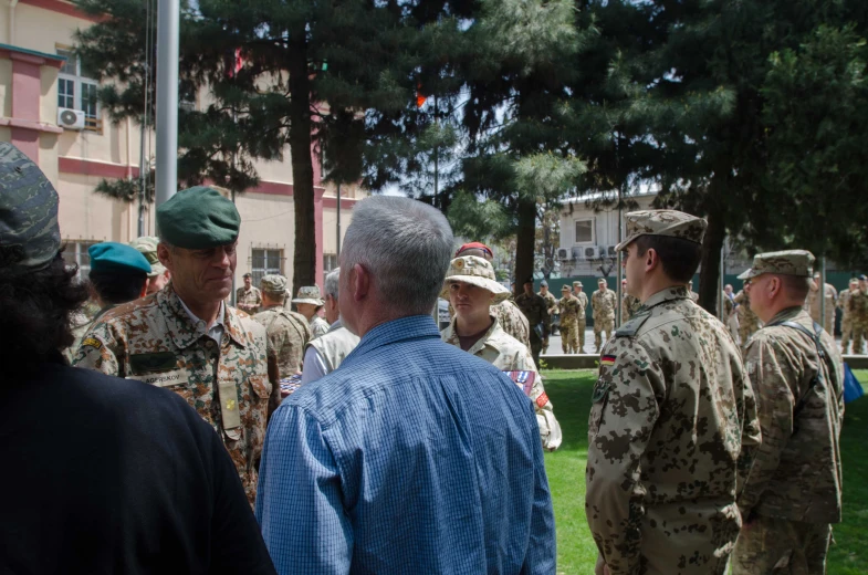 the men are talking to each other in a group