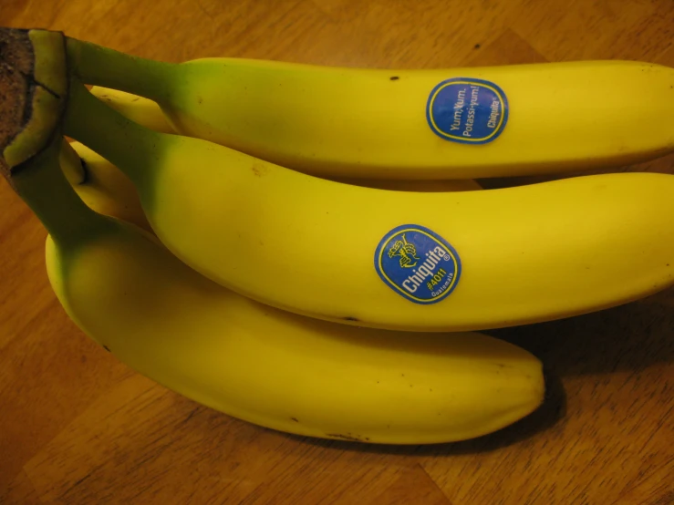 some bananas are sitting on a wooden table