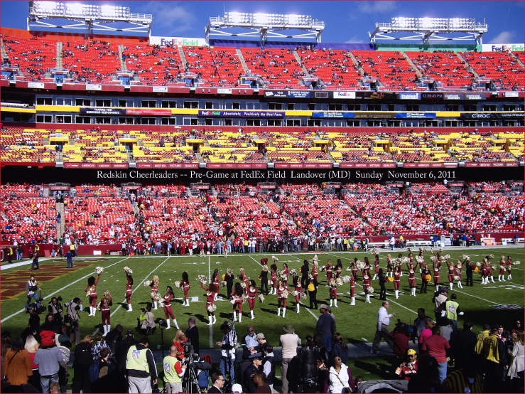 a stadium filled with red and yellow seats and lots of fans