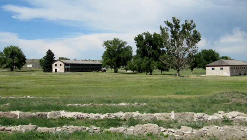 two houses sit near the grass in the middle of the afternoon