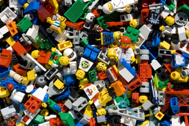 a large pile of colorful lego parts in a pile
