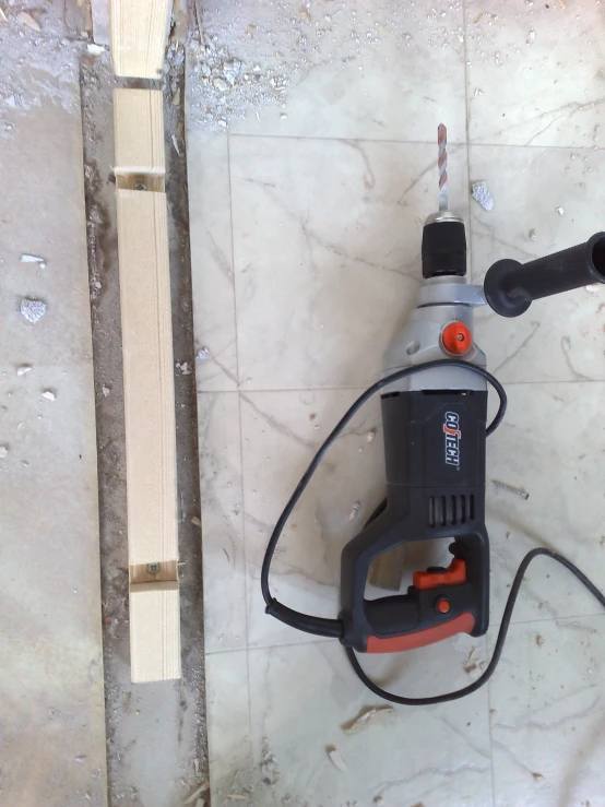 a cordless drill with a power tool is set up in the concrete