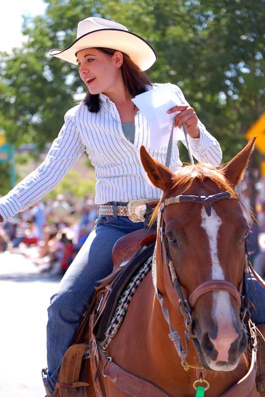 a young woman rides her horse at a parade