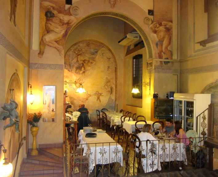 this restaurant is painted with murals on the walls