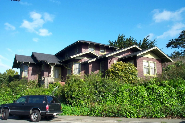 a black truck parked in front of a house