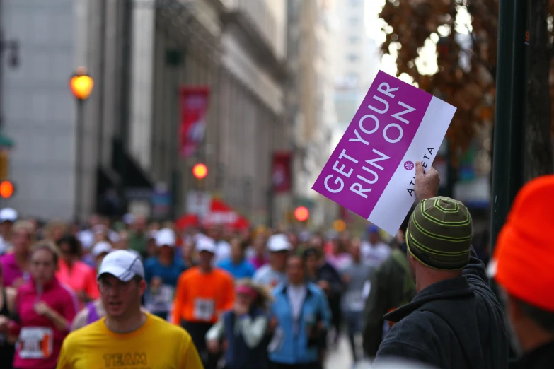 a man with a sign that reads run your own