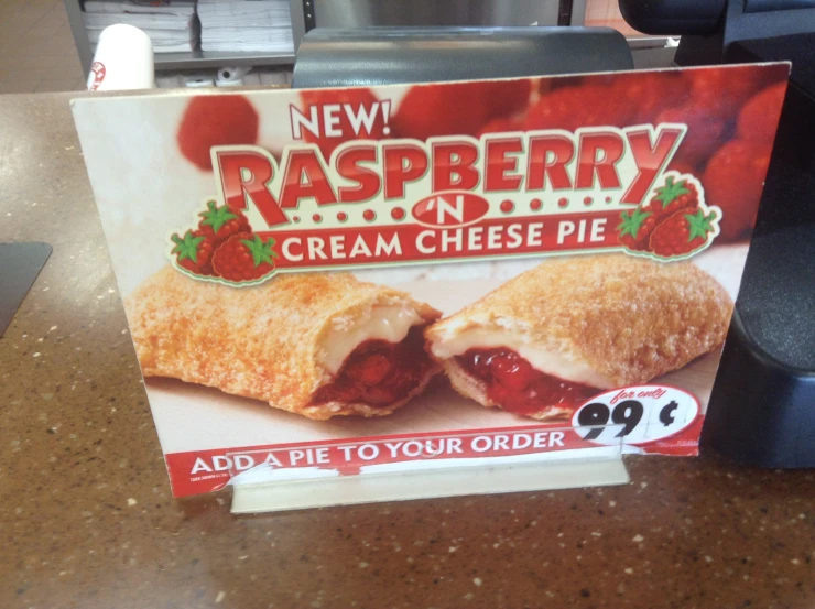 a sign advertising raspberry cream cheese pie
