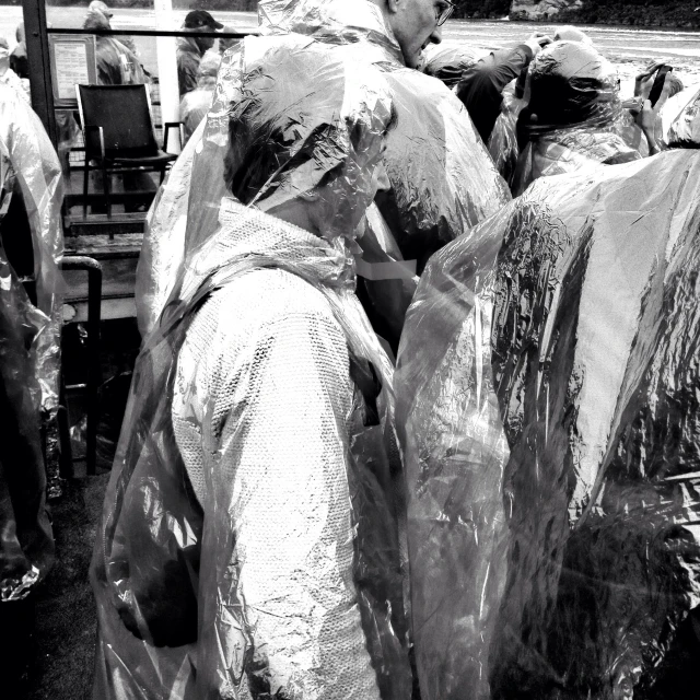 a man carrying bags of food is wrapped in plastic