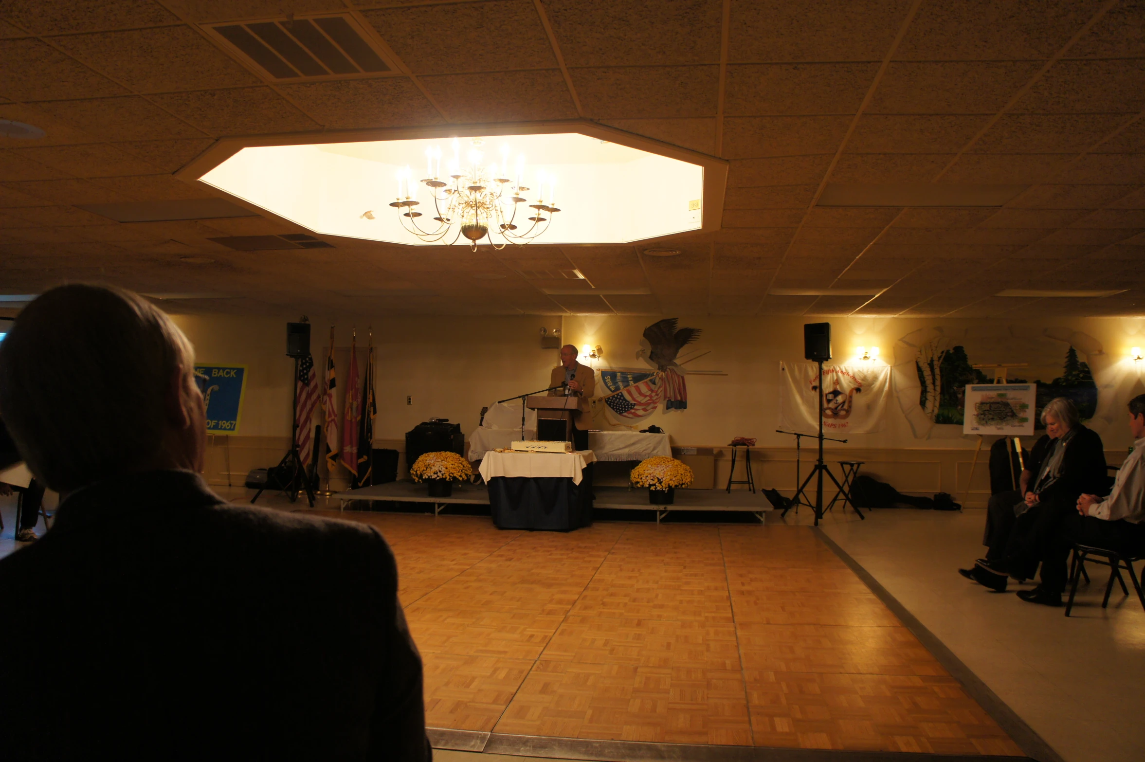 an event hall with people sitting and standing