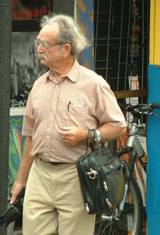 an old man holding a handbag walking down the street