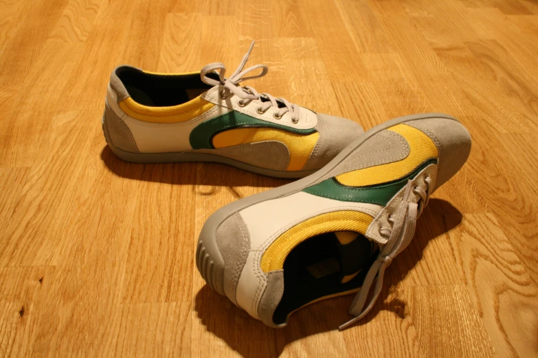 an old pair of sneakers on a wooden floor