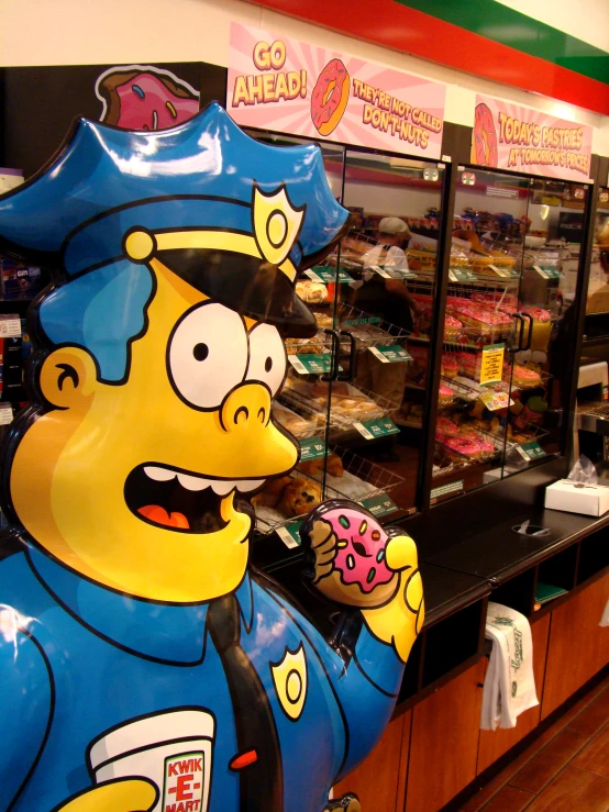 a large sculpture of a cartoon character eating doughnuts