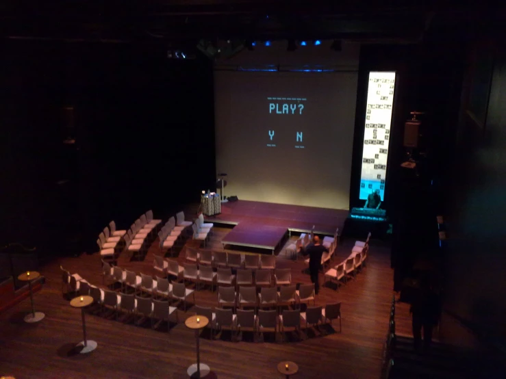 empty theater chairs are positioned on the stage