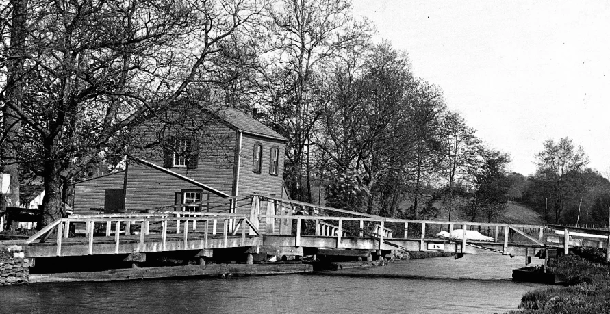 an old house on the river with its bridge to get away