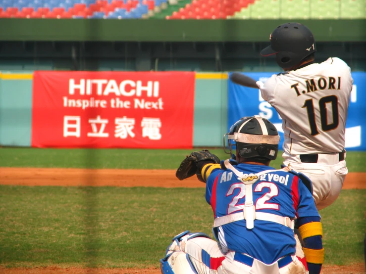 a baseball player is reaching to bunt a baseball