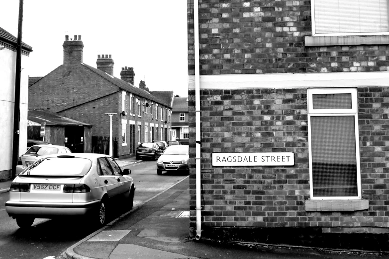 a street scene with cars parked on the side walk