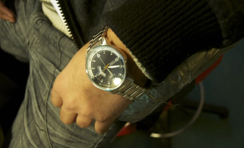 a person with a wristwatch on their wrist