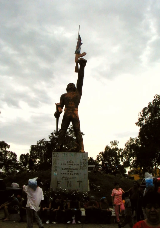 a statue of a person holding an american flag