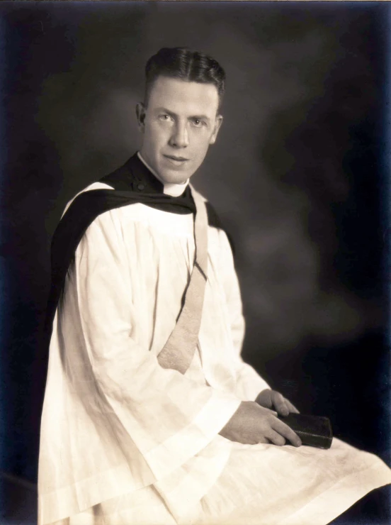 a man in religious garb sitting down