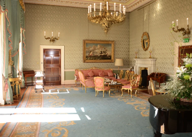 a living room with fancy chandeliers hanging above it