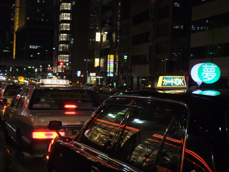 a busy street full of parked cars in the city