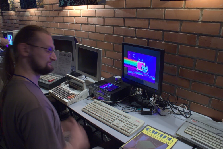 a man at a desk with two computers