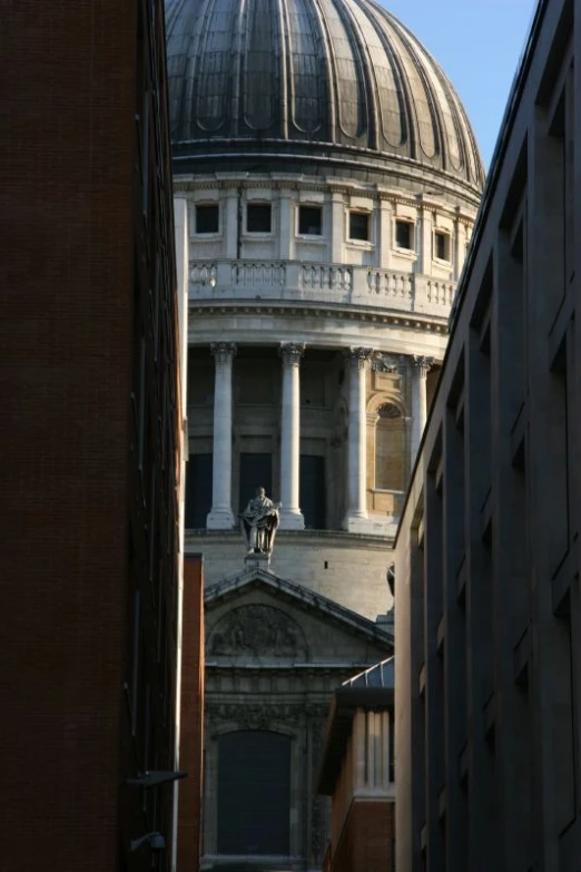 a dome structure is in the middle of two buildings