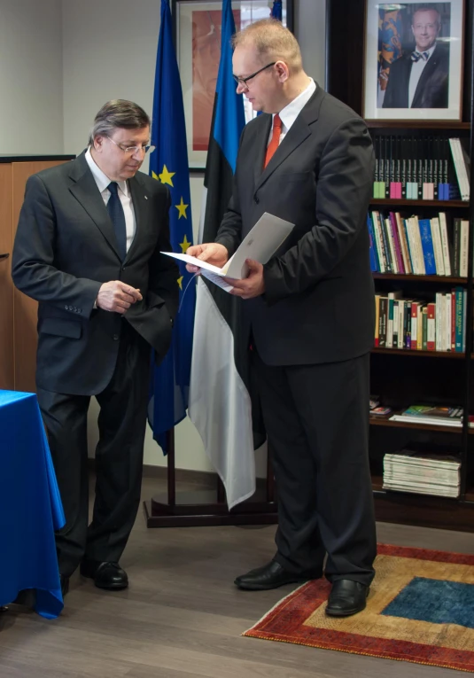 a man in suit and tie at a signing ceremony