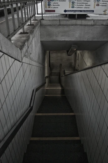the stairway leads to a sign that warns of an accident