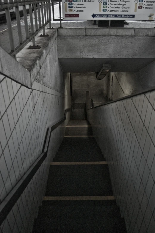 the stairway leads to a sign that warns of an accident