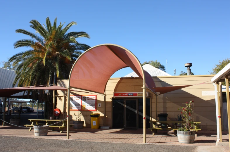 several different pavilions with palm trees and people walking on them