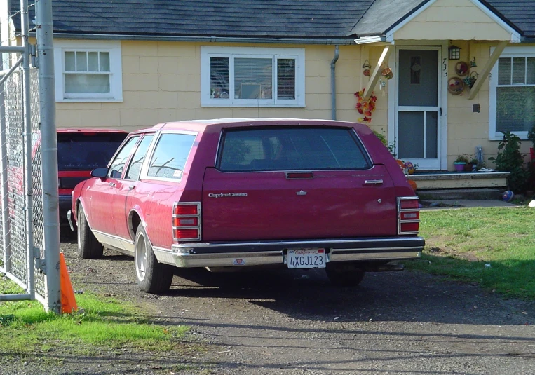 a car parked on the driveway next to a home