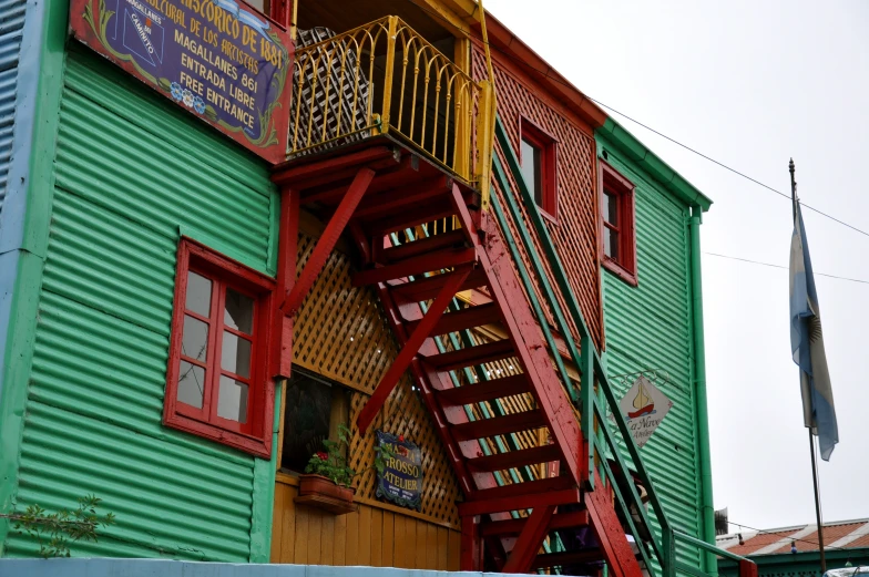 a red and green ladder that is hanging up