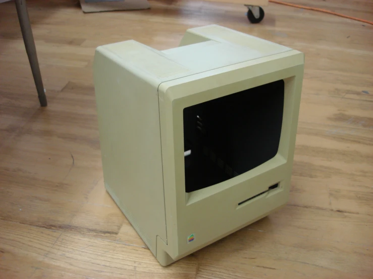 a macintosh desktop computer sitting on top of a wooden floor