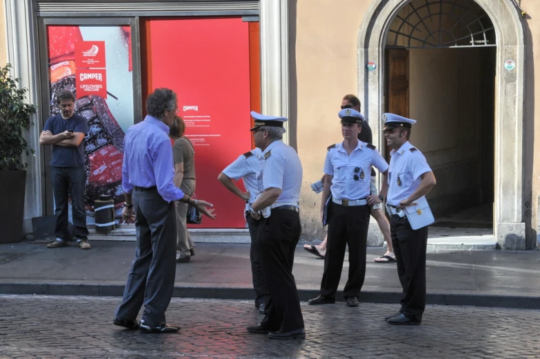 a group of police men standing in front of a building