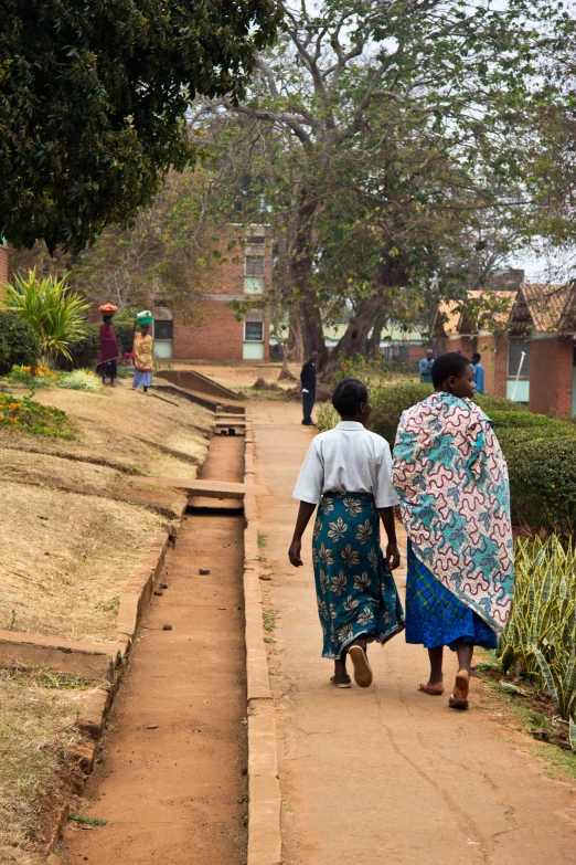 two people walking together down a path