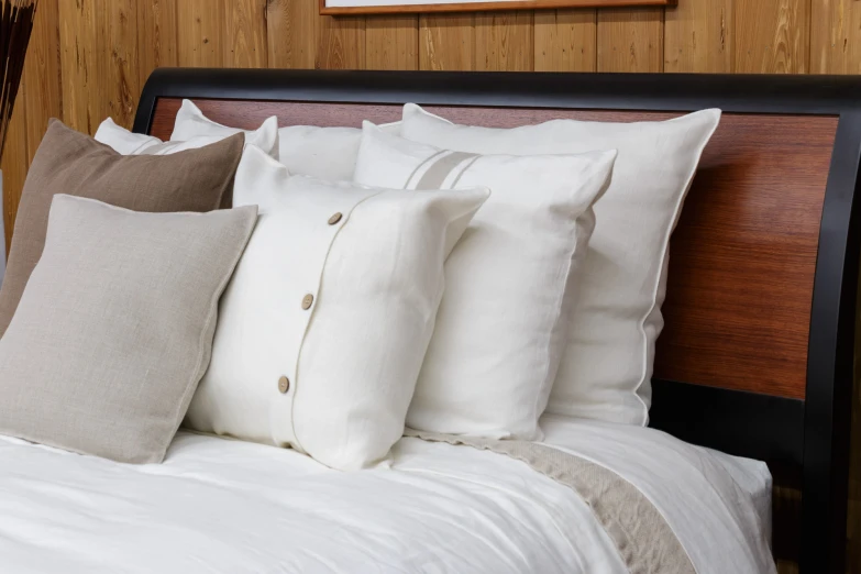 pillows are stacked on a bed headboard
