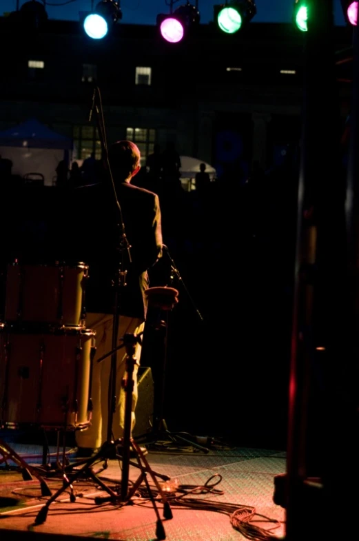 a man playing drums in a dimly lit area