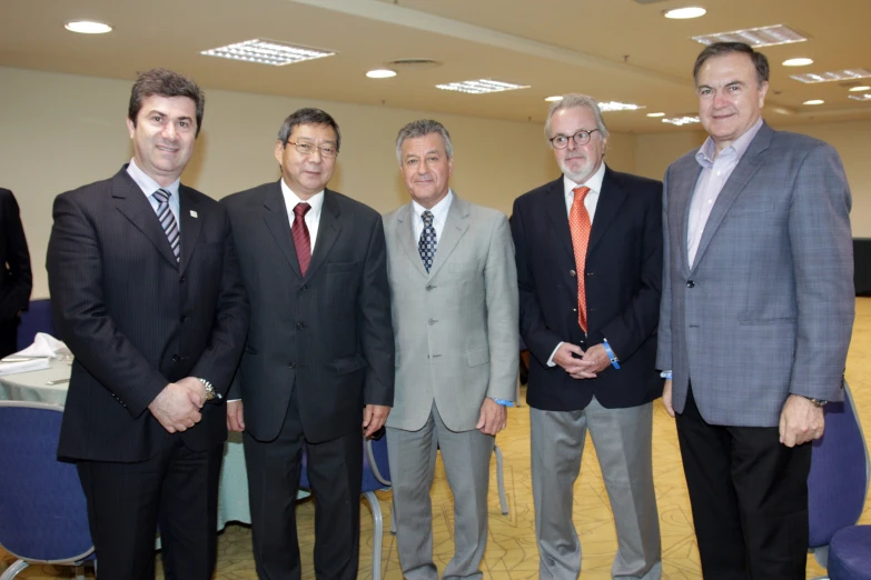 five men standing next to each other in business suits