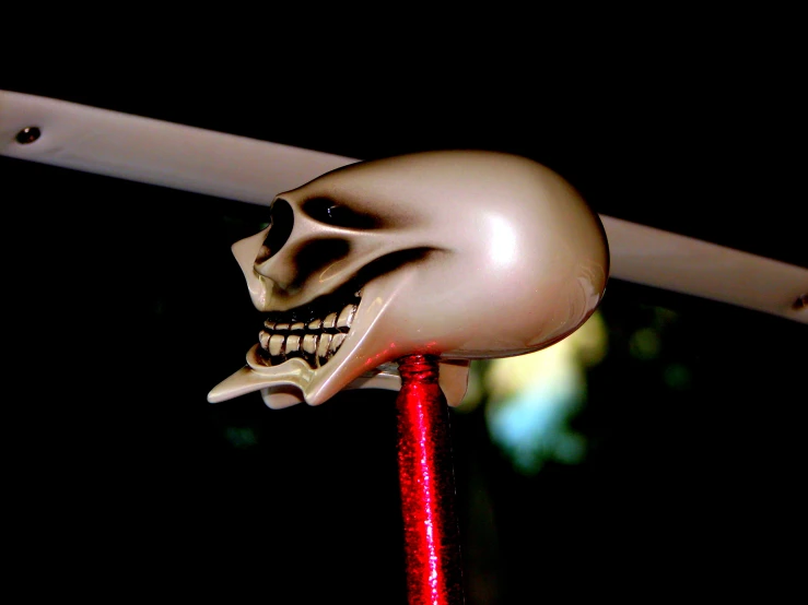 skull statue with red eye standing on red string