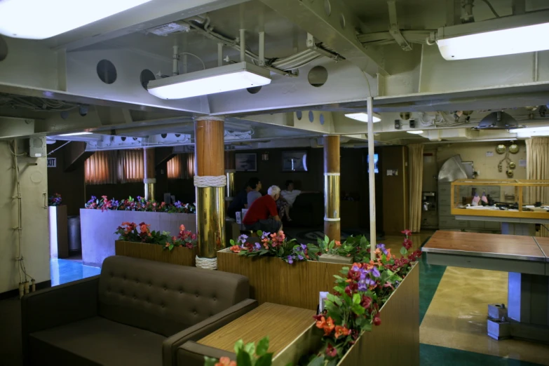 people in an open kitchen that looks out onto a swimming pool