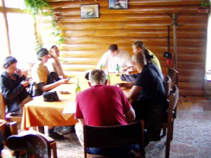 a bunch of people sitting around a table at a restaurant