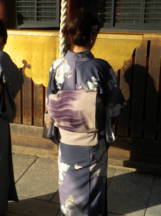 two women in geisha dress are standing together