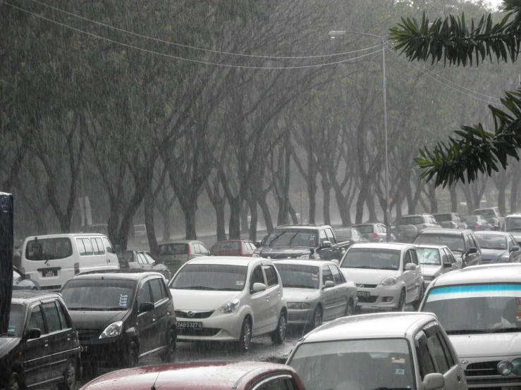 a car filled with traffic sitting on a rain soaked road