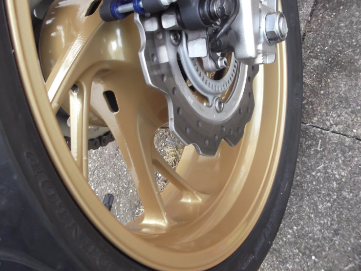 the rim of a vehicle with gold colored wheels