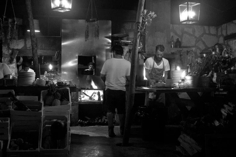 two men cooking in an old looking kitchen