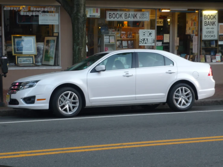 a white car parked on the side of the road