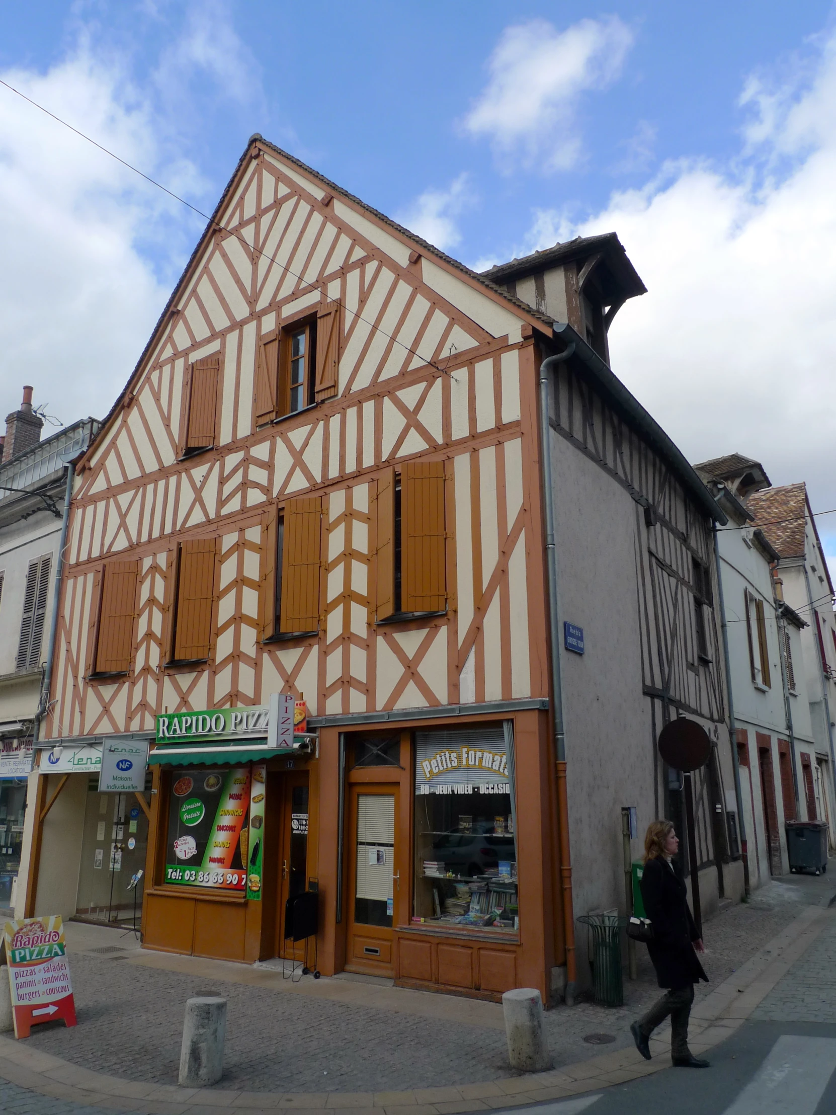 an old building with a striped pattern and shutters