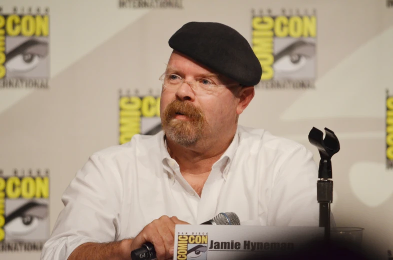 a man with a hat sitting at a table