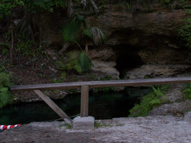 a small bridge has two pillars and a wooden board on it